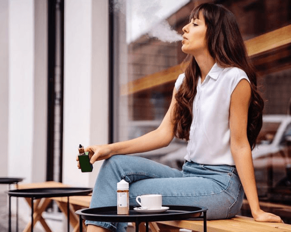 woman sitting on patio vaping