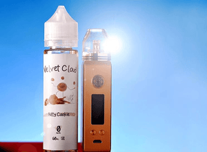 Velvet Cloud Nutty Cookie e-liquid next to a box mod on a sunny day