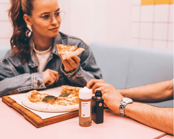 woman vaping at restaurant