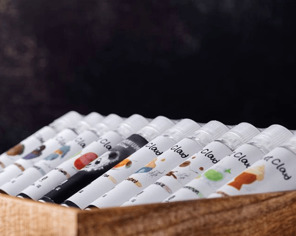 different flavors of vape juice sitting in wooden box
