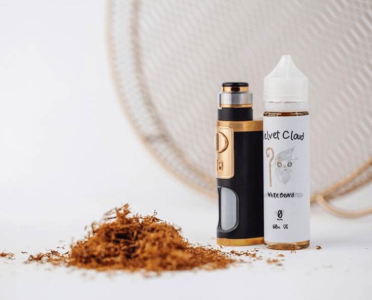 an image of Velvet Cloud's white beard e-liquid next to a vape mod