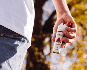 a close-up photo of man holding a bottle of Campfire e-liquid from Velvet Cloud