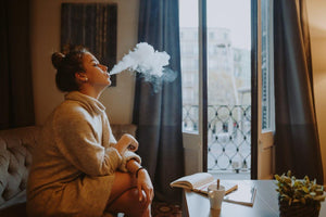 woman vaping in apartment