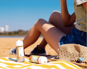 woman sitting on beach with vape juice