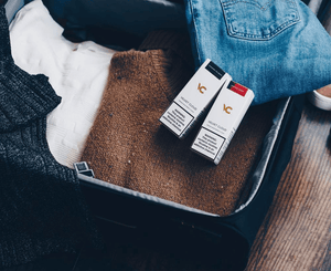 suitcase prepared for business trip or vacation with e-liquids for vaping