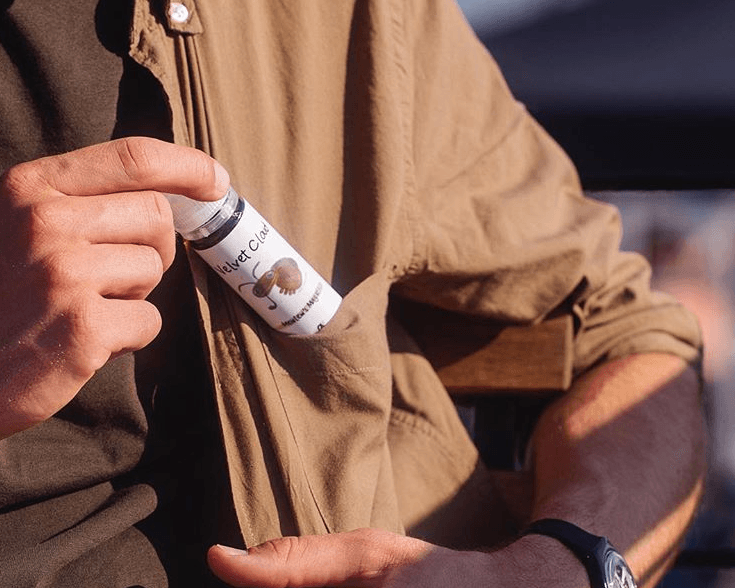 a man hiding e-liquid in his coat pocket while attempting to stealth vape