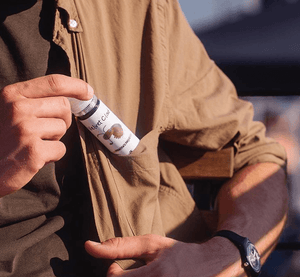 a man hiding e-liquid in his coat pocket while attempting to stealth vape