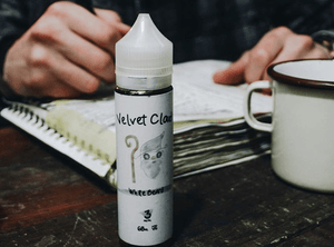 a man writing about the history of vaping with a bottle of e-liquid in the foreground