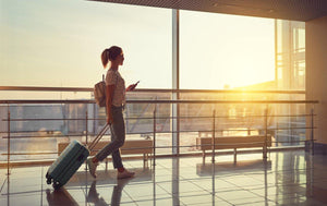 woman walking through airport at sunset