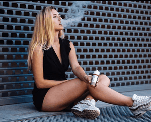 woman vaping and holding Velvet Cloud e-liquid